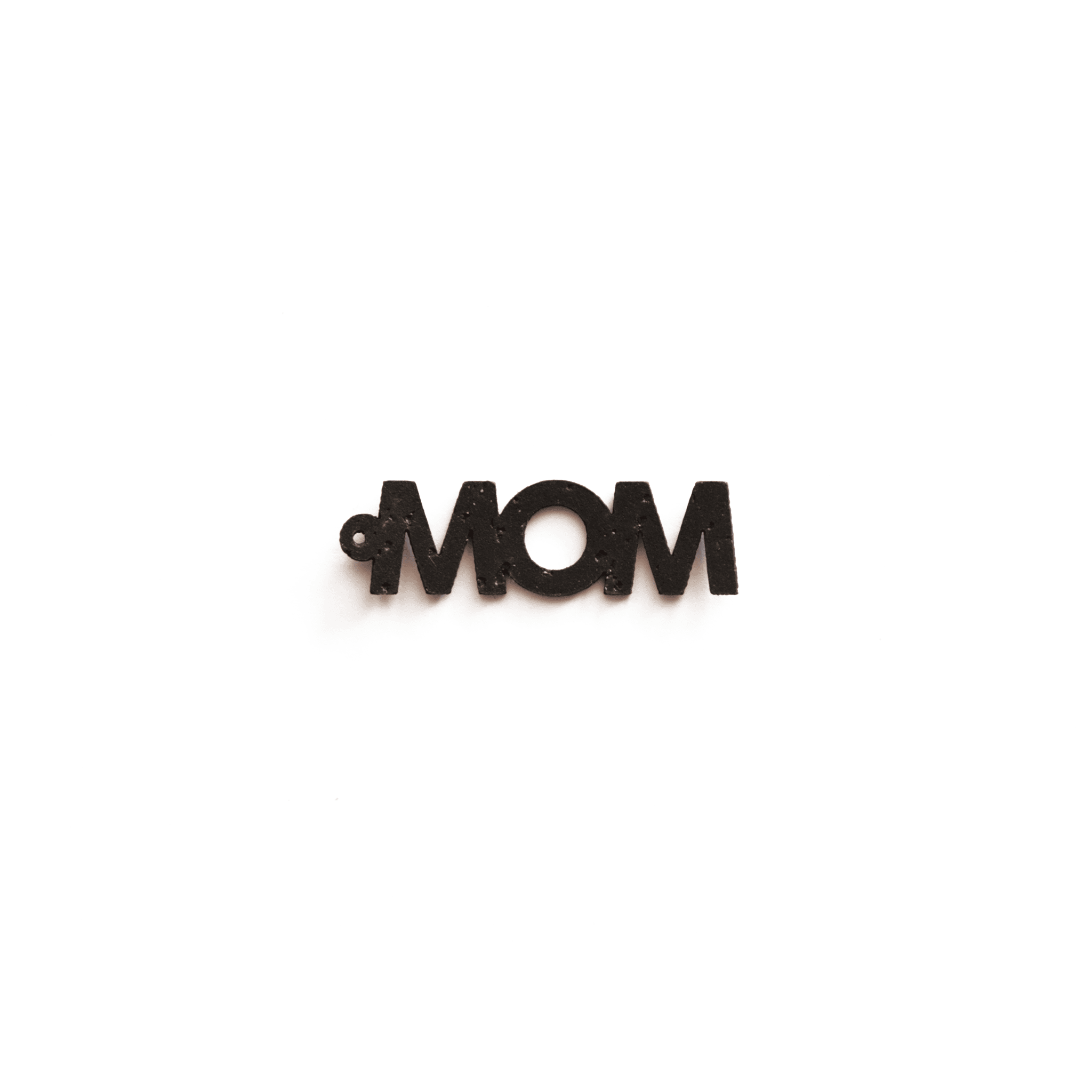 Breloque noire avec le mot "MOM", en matériau vegan, vue de face sur fond blanc, bijou éthique et personnalisable de la marque Matcha Paris.