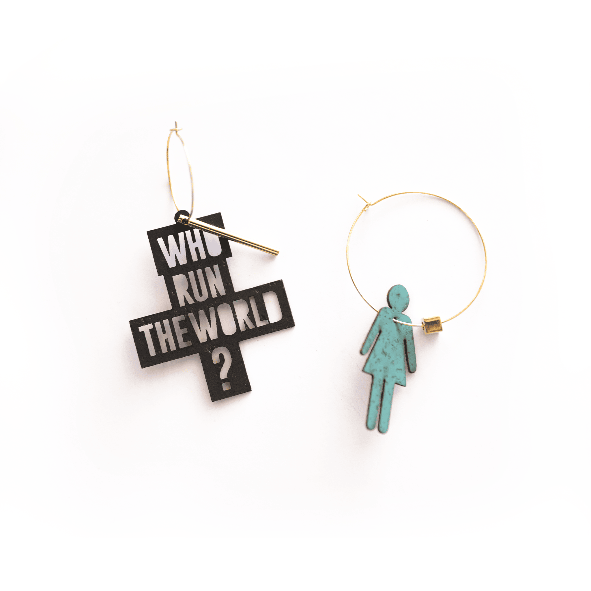 Boucles d’oreilles asymétriques dorées inspirées de la chanson de Beyoncé "Who Run the World (Girls)" : une créole avec breloque noire inscrite "Who Run the World ?" et une créole assortie avec pendentif turquoise en forme de silhouette féminine. Bijoux féministes personnalisables fabriqués en France.