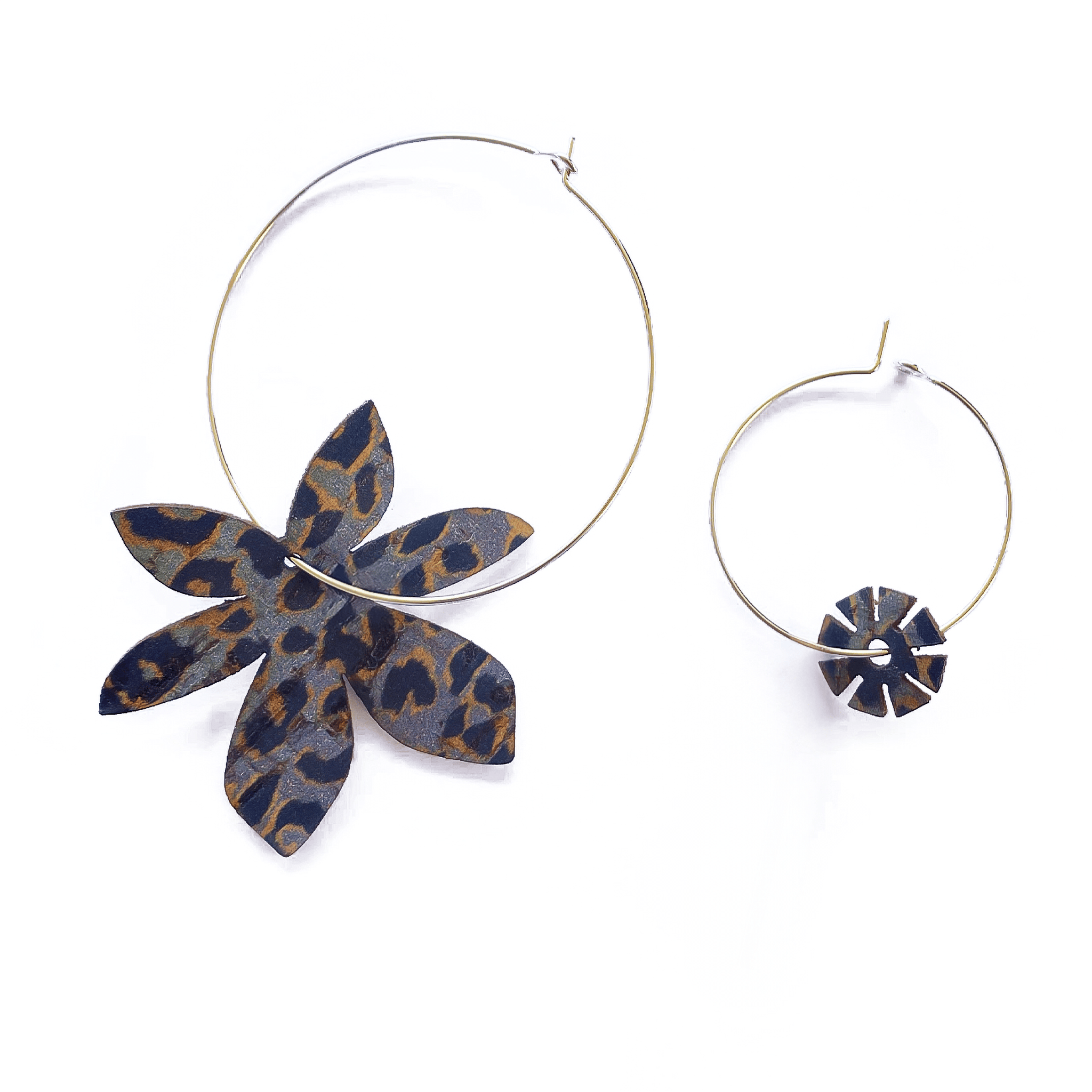 Ces boucles d'oreilles dépareillées Brangelina associent une grande créole argentée avec fleur en cuir imprimé léopard à une mini créole charm floral assorti. Un duo asymétrique fabriqué artisanalement en France, pour un style rock affirmé et une touche sauvage au quotidien.